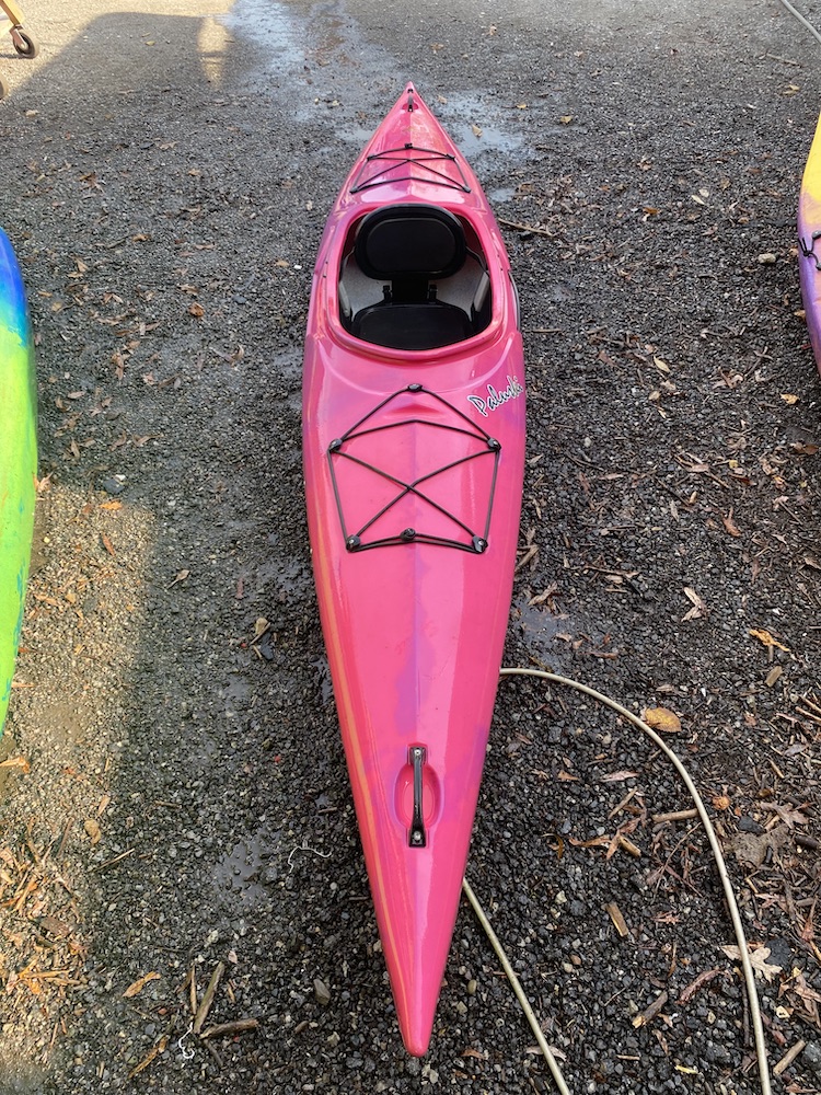 a pink kayak on gravel road